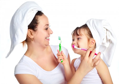 Mother and Daughter Brushing Teeth
